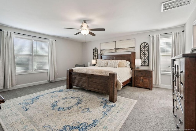 bedroom with carpet floors, baseboards, visible vents, and a ceiling fan