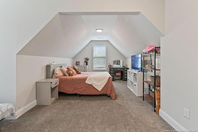 carpeted bedroom with lofted ceiling and baseboards