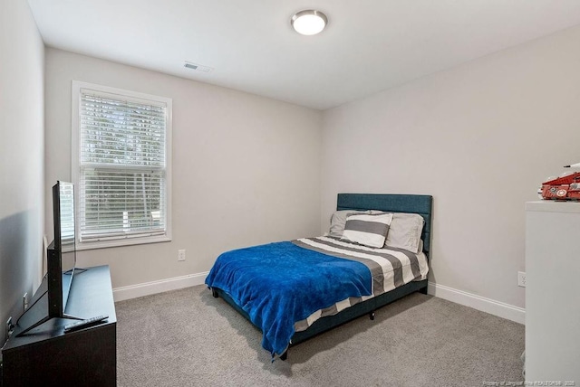 bedroom with carpet flooring, visible vents, and baseboards