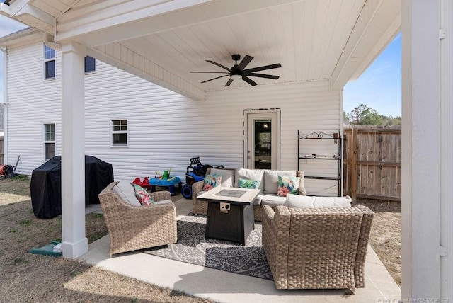 view of patio / terrace with a ceiling fan, a grill, an outdoor living space with a fire pit, and fence