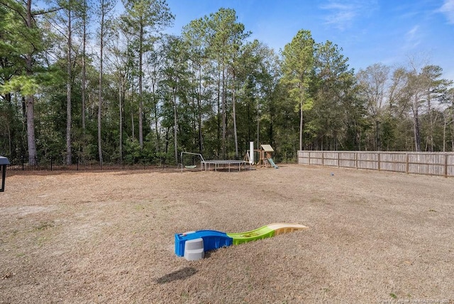 exterior space with a playground and fence