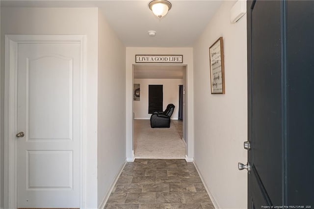 hall with stone finish floor and baseboards