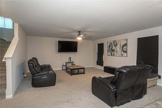 carpeted living area featuring ceiling fan, stairs, visible vents, and baseboards