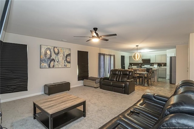 living area with carpet floors, ceiling fan, visible vents, and baseboards