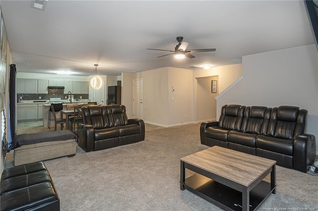 living room with a ceiling fan, carpet, visible vents, and baseboards