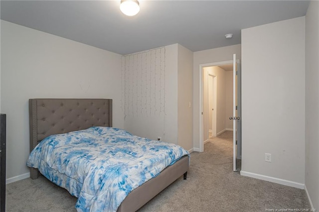 bedroom with baseboards and carpet flooring