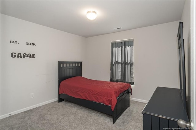 carpeted bedroom with visible vents and baseboards