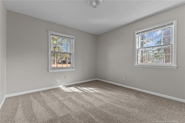 spare room with carpet flooring and baseboards