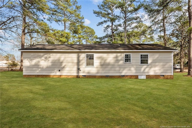 rear view of house featuring crawl space and a yard