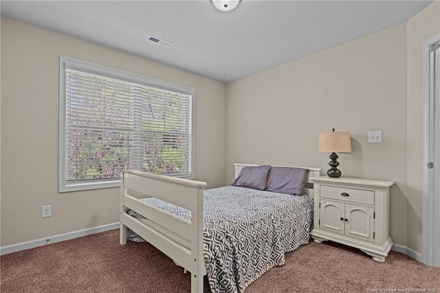 bedroom with carpet floors, visible vents, and baseboards