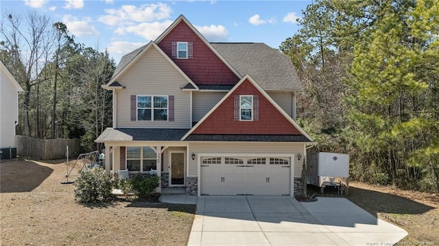 craftsman-style house with a shingled roof, an attached garage, fence, stone siding, and driveway