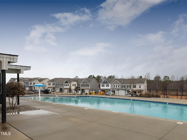 pool featuring a residential view and fence