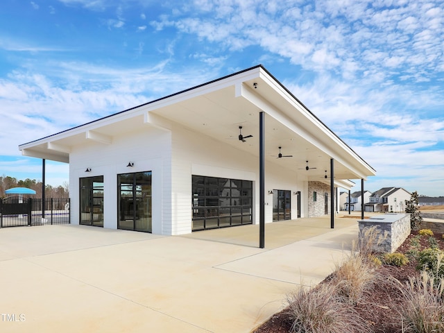 view of building exterior featuring a garage and fence