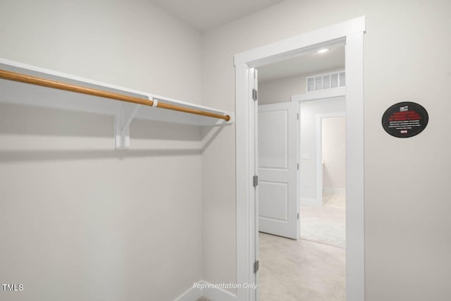 spacious closet featuring visible vents