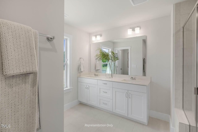 bathroom with double vanity, visible vents, a sink, tiled shower, and baseboards