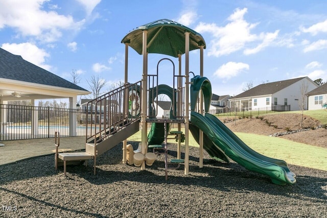 community jungle gym with fence and a residential view