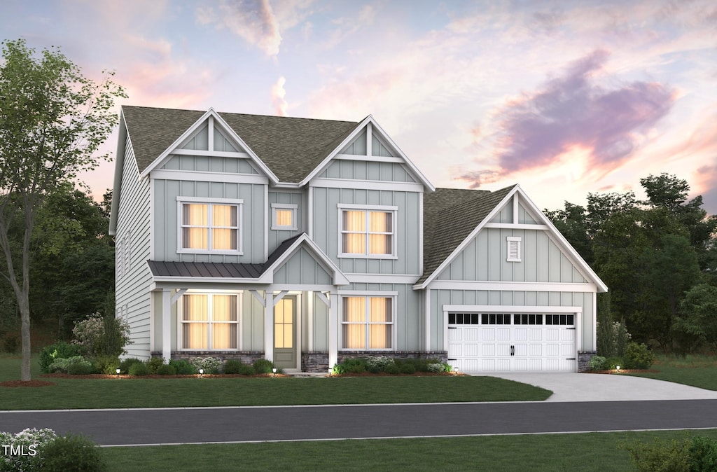 view of front of home with a yard, a shingled roof, and board and batten siding