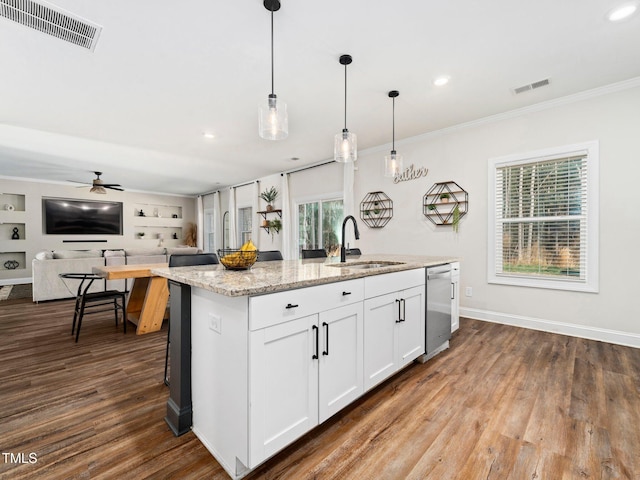 kitchen with a sink, visible vents, stainless steel dishwasher, and an island with sink