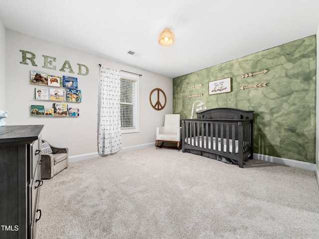 bedroom with visible vents, baseboards, carpet floors, a fireplace, and a crib