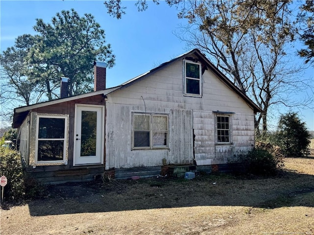 rear view of property with a chimney