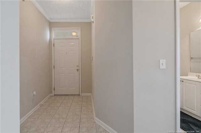 interior space featuring a textured ceiling, baseboards, and crown molding