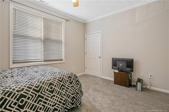 carpeted bedroom with ceiling fan, ornamental molding, visible vents, and baseboards