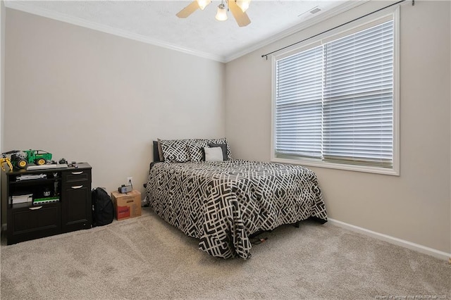 carpeted bedroom with visible vents, crown molding, baseboards, and ceiling fan