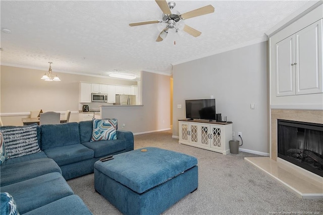 carpeted living area featuring ornamental molding, a fireplace with raised hearth, a textured ceiling, and baseboards