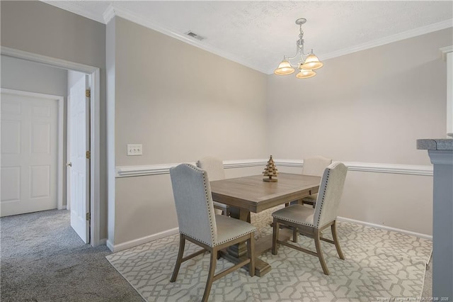 carpeted dining space with a chandelier, ornamental molding, visible vents, and baseboards