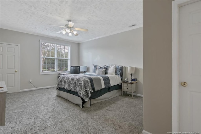 bedroom with carpet, baseboards, and a textured ceiling