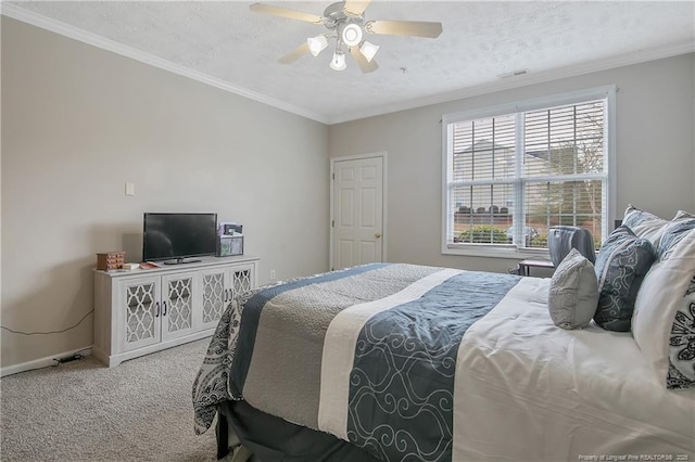 carpeted bedroom featuring ornamental molding, a textured ceiling, and a ceiling fan