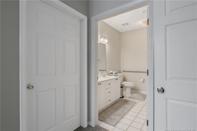 bathroom featuring toilet, visible vents, tile patterned flooring, and vanity