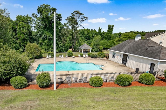 community pool featuring a yard, a patio area, fence, and a gazebo