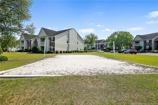 view of property's community with volleyball court, a residential view, and a yard