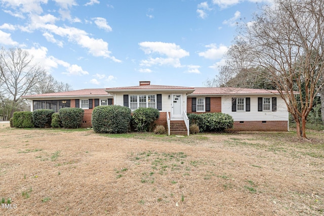 ranch-style house with crawl space, brick siding, and a front lawn