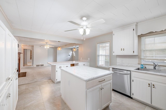 kitchen with visible vents, a sink, stainless steel dishwasher, a center island, and a peninsula