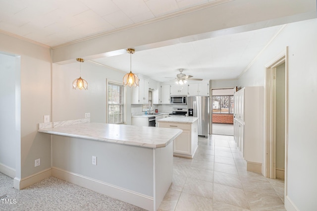 kitchen with a peninsula, crown molding, a healthy amount of sunlight, and appliances with stainless steel finishes