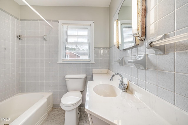 bathroom featuring toilet, shower / bathing tub combination, tile walls, tile patterned flooring, and vanity