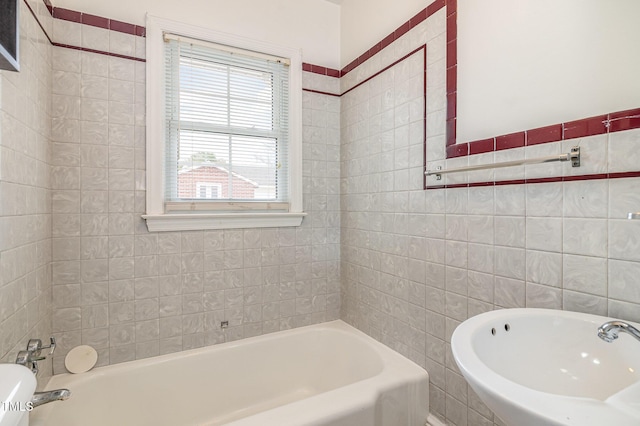 full bath with tile walls and a washtub