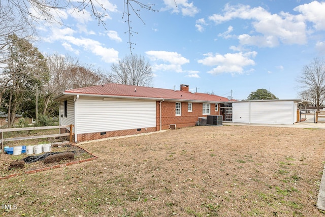 back of property featuring metal roof, a yard, fence, and crawl space