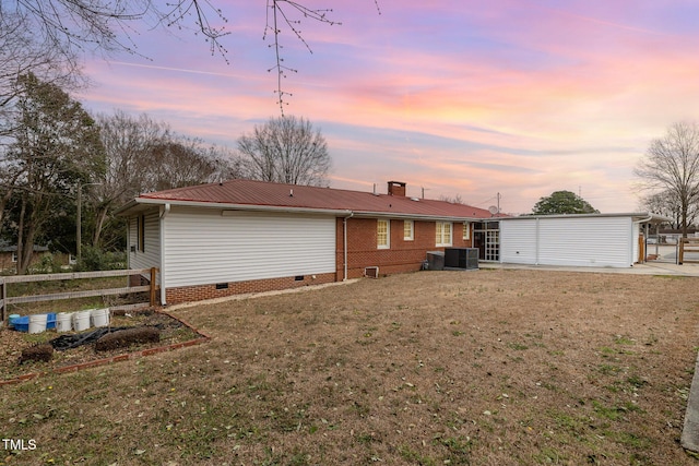 rear view of house with fence, a yard, central AC, crawl space, and metal roof