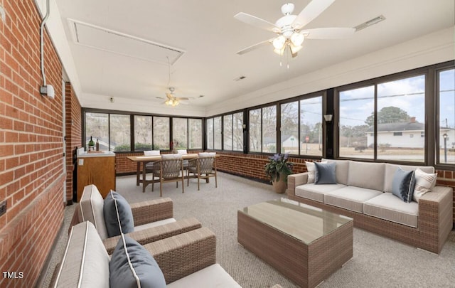 sunroom / solarium featuring visible vents and a ceiling fan