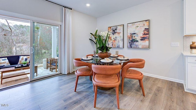 dining space with recessed lighting, light wood-style flooring, and baseboards