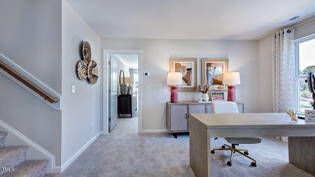 office space with baseboards, visible vents, and light colored carpet