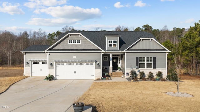 craftsman inspired home featuring driveway, an attached garage, a front lawn, and roof with shingles