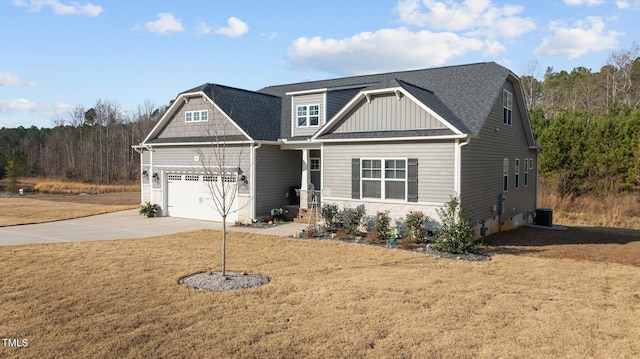 craftsman inspired home with concrete driveway, a shingled roof, board and batten siding, and a front yard