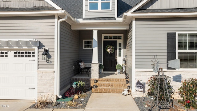 view of exterior entry with brick siding, a shingled roof, a porch, an attached garage, and board and batten siding