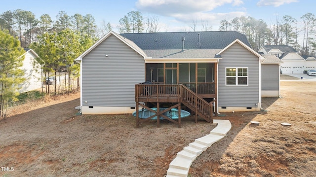 back of property featuring a sunroom, crawl space, a shingled roof, and stairs