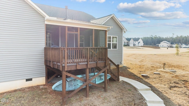 deck featuring a sunroom and stairs