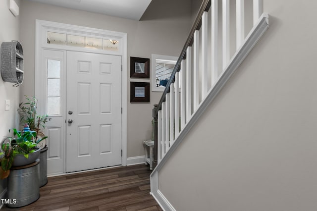 entrance foyer with dark wood-type flooring, stairway, and baseboards